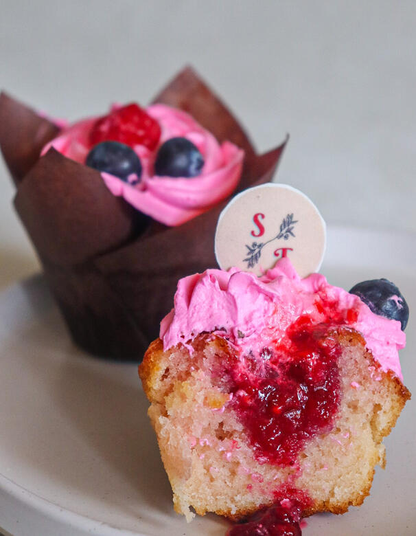 Experience a berry explosion in every bite with our Raspberry Cupcake. This exquisite treat features a light and fluffy raspberry cupcake, filled with a delightful raspberry filling, and crowned with a luscious blueberry frosting. The combination of tangy